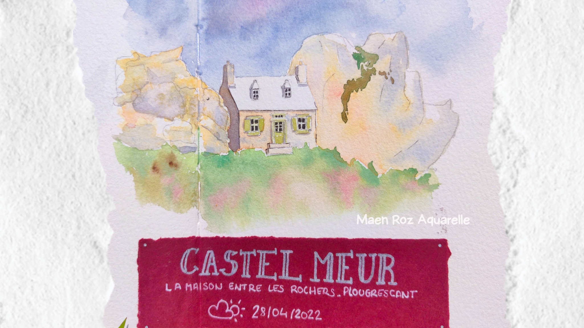 Page de carnet de voyage à l’aquarelle représentant une maison bretonne entre les rochers, avec annotation manuscrite